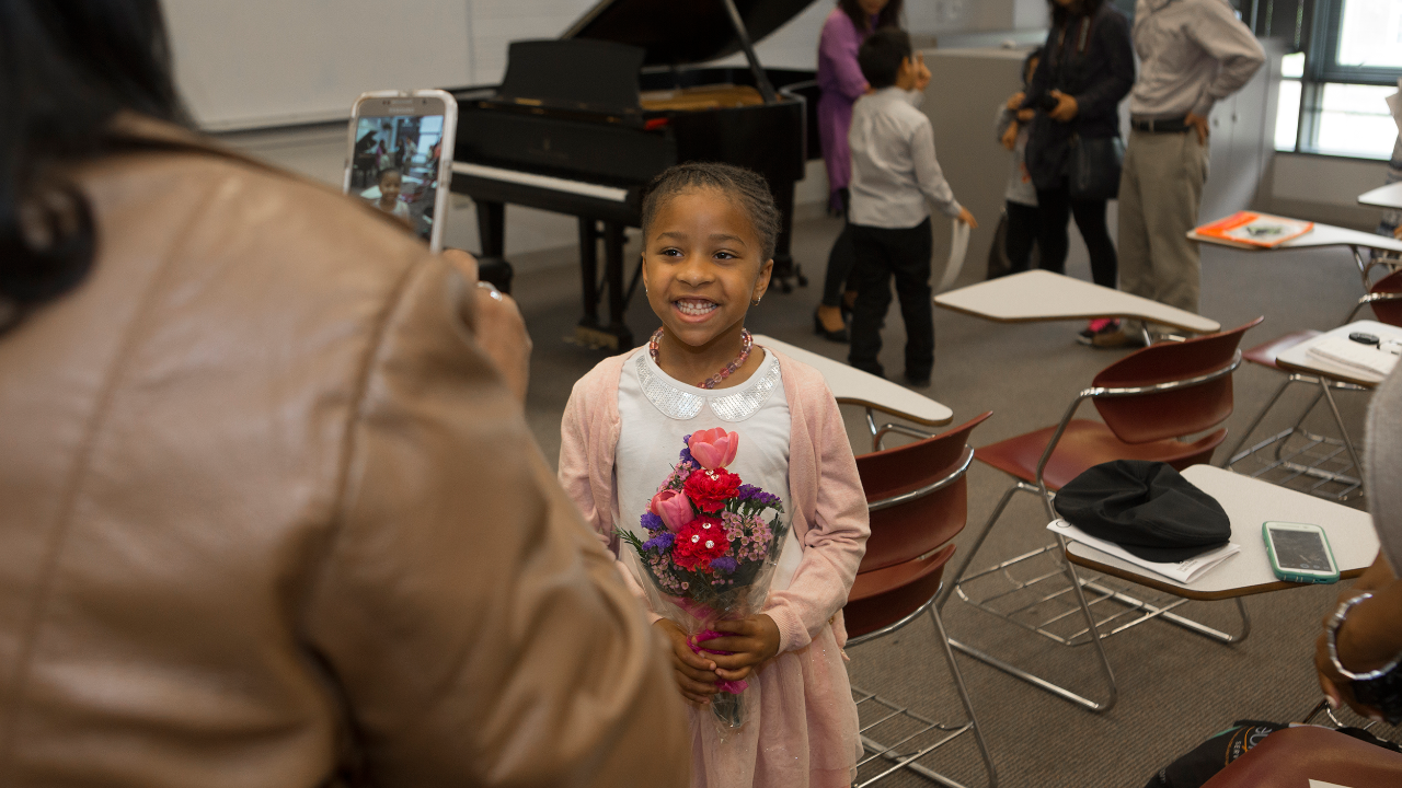 A proud parent takes a photo of their CCM Prep student