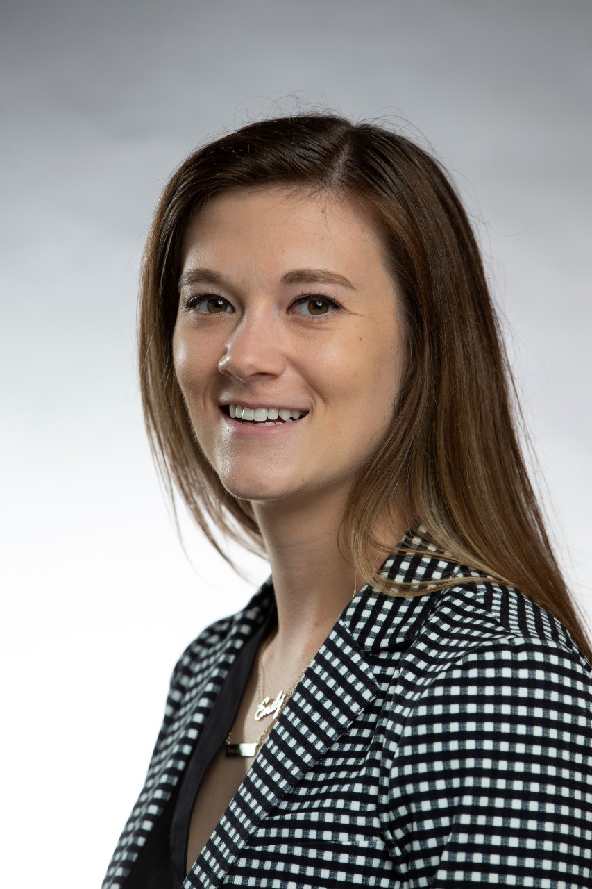 Woman in professional attire smiling at camera