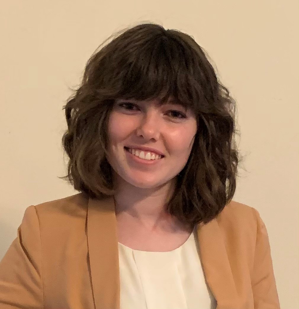 Woman in professional attire smiling at camera