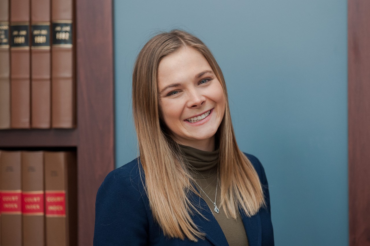 Woman in professional attire smiling at camera