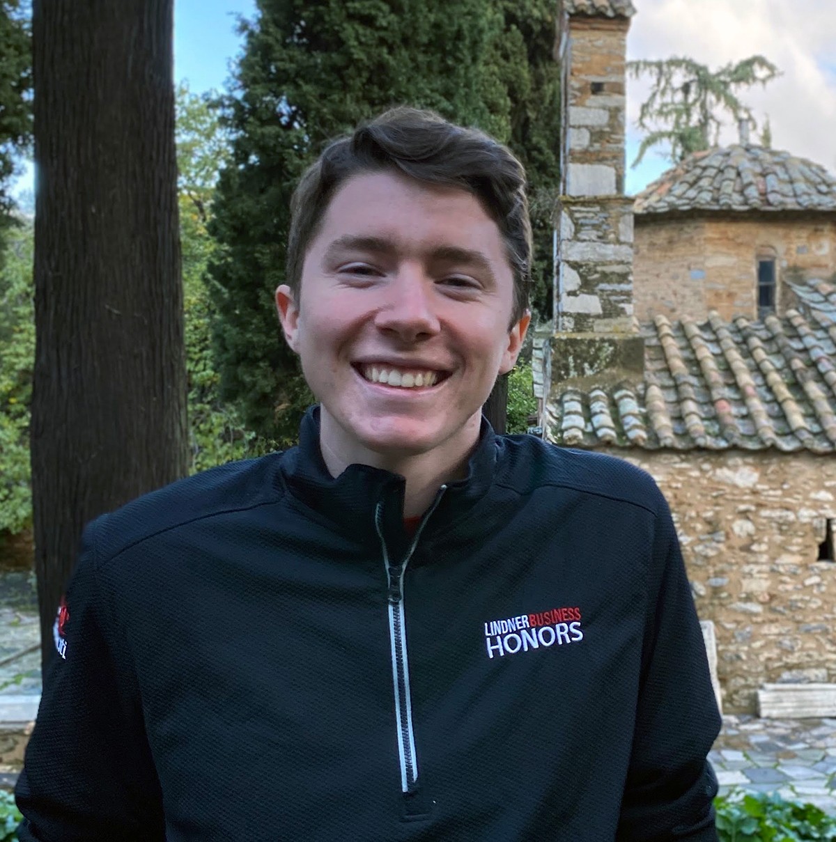 Image of white young man in black fleece jacket