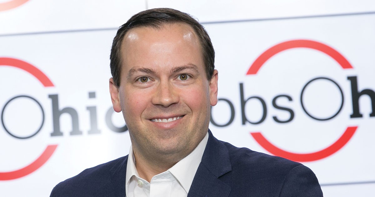 portrait of a man in front of a JobsOhio banner