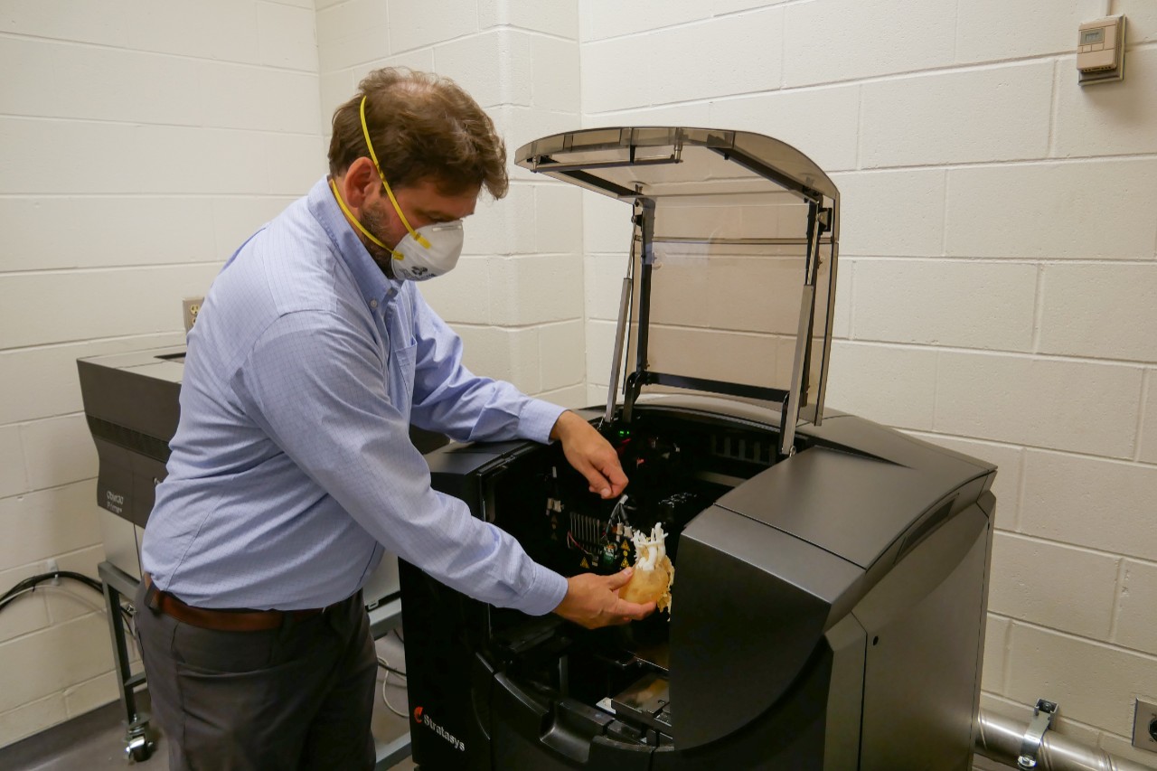 Sam Antoline uses a 3D printer.