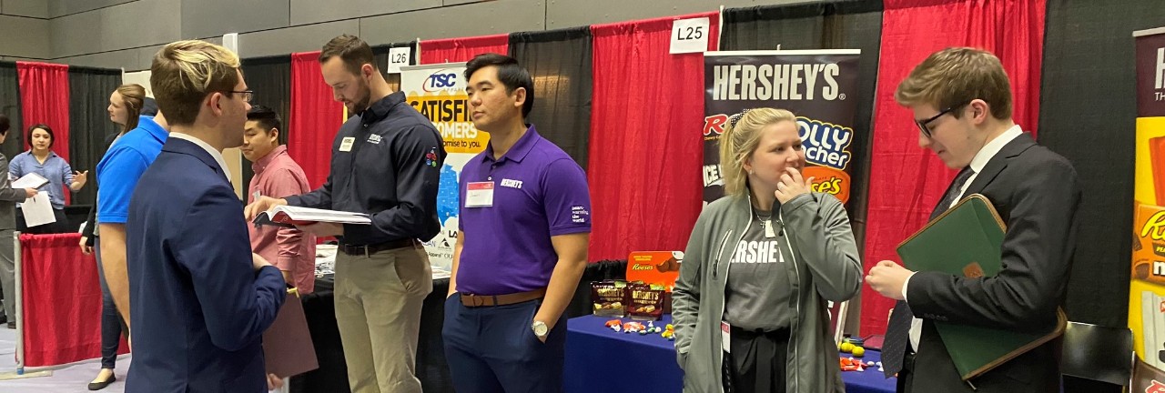 recruiters lined up to speak with students at a career fair