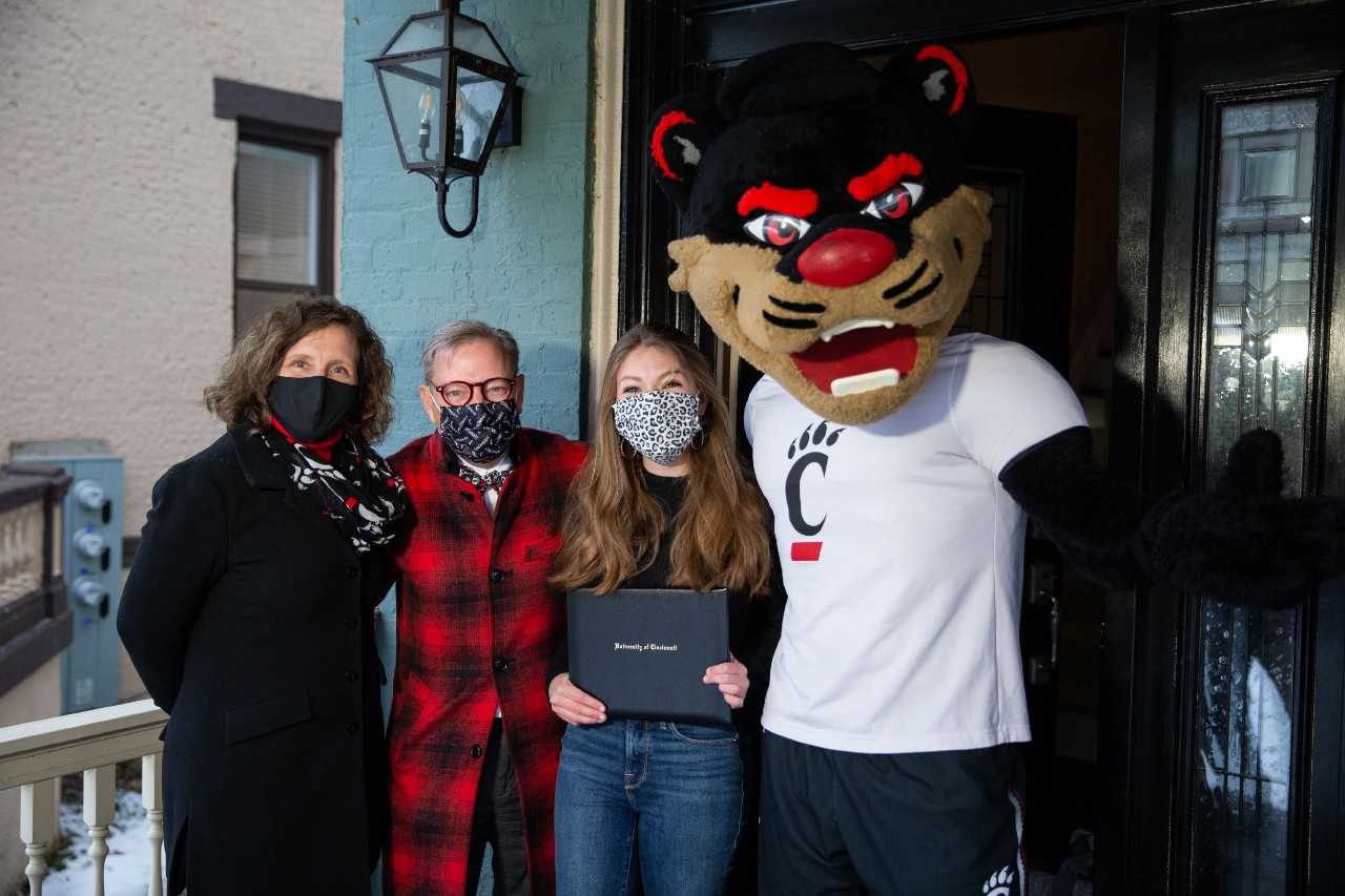 A group photo on the porch of a UC student who just found out she will be attending UC in the Fall of 2021.