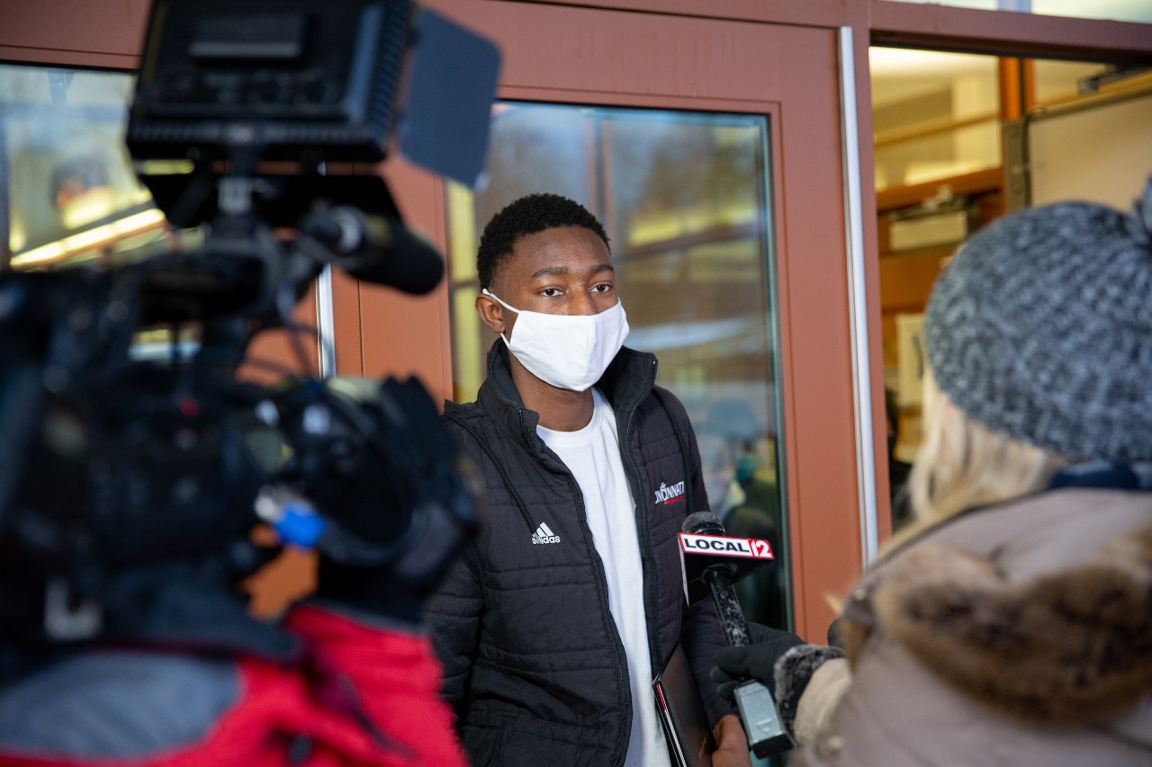 Members of the UC community, including Jack Miner and the Bearcat, surprise Mohamed Camara to congratulate him on his admission to UC.