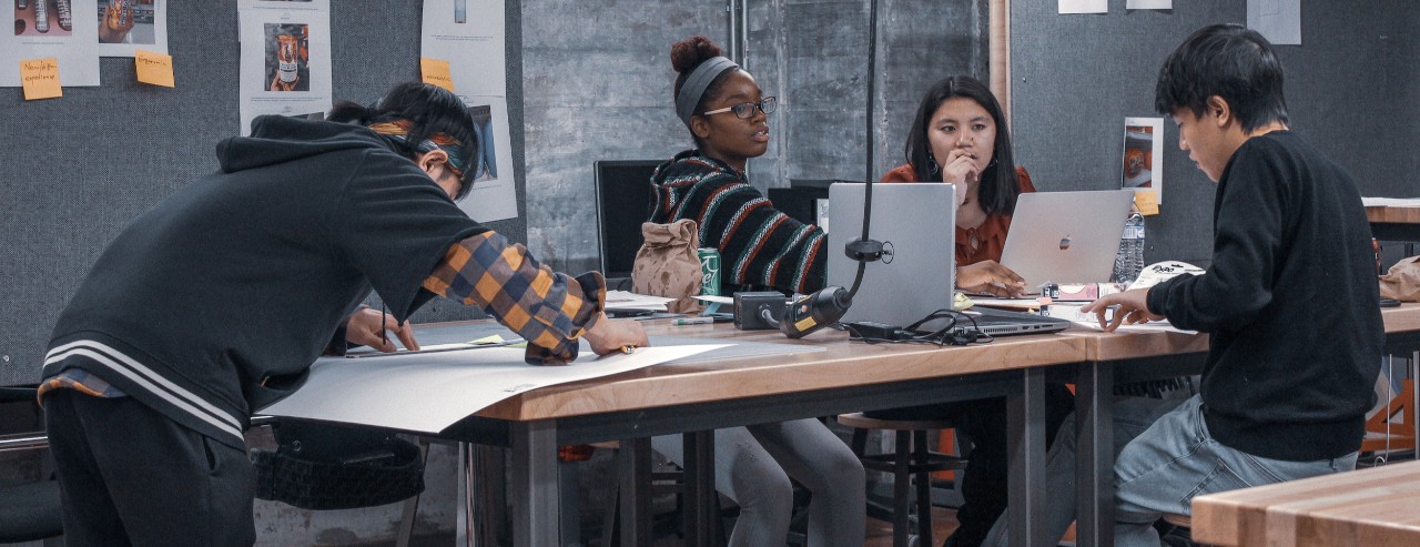 College students collaborating around table during KAO event in UC's 1819 Innovation Hub