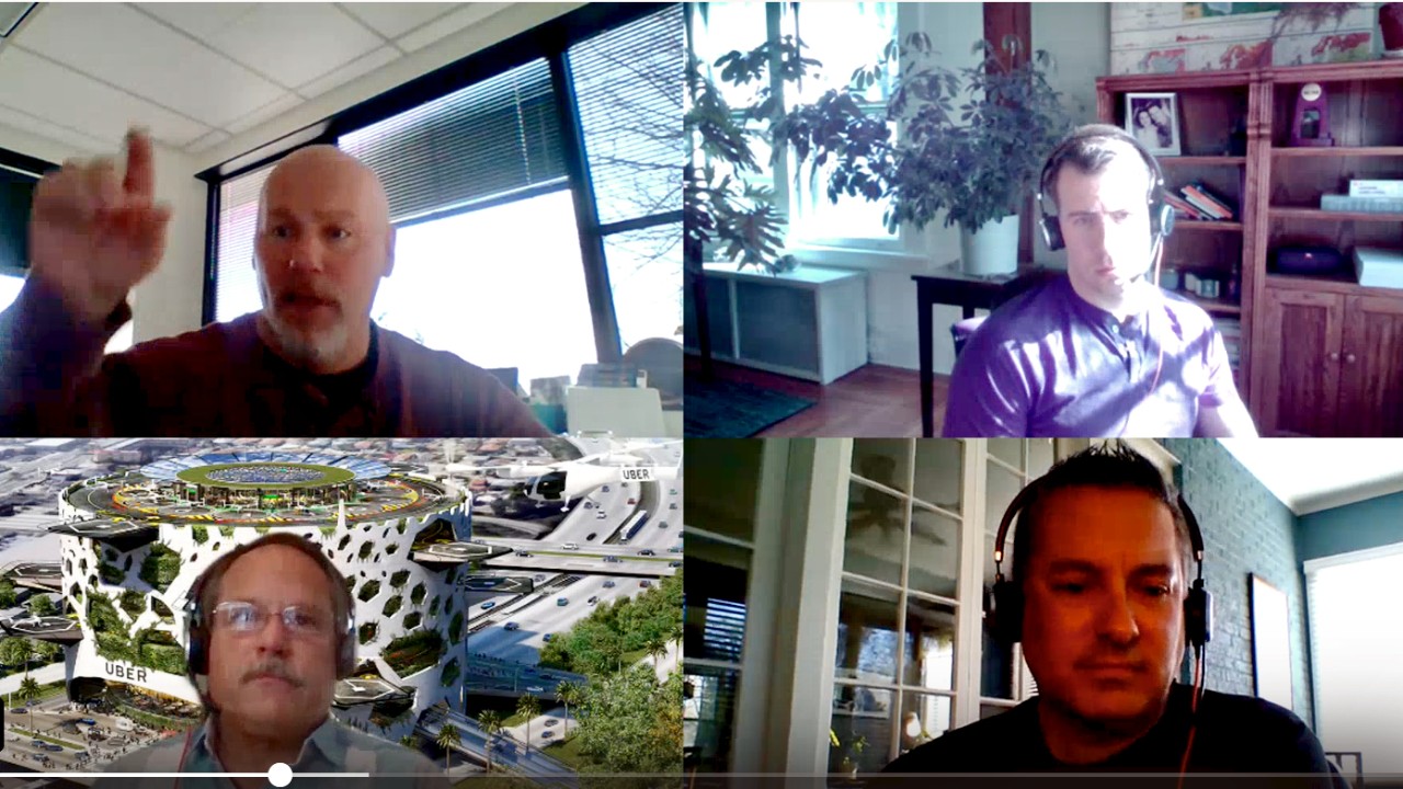 Four men on a computer screen in a virtual meeting.