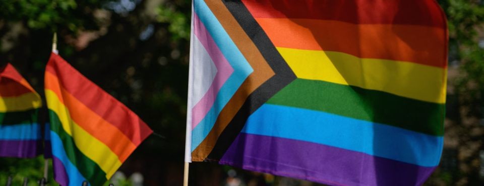 a photo of progress and pride flags