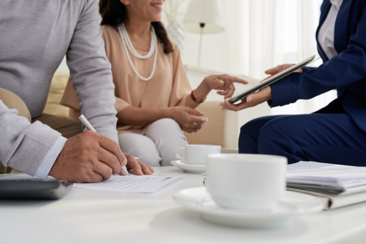 Cropped image of senior couple signing contract with real estate manager