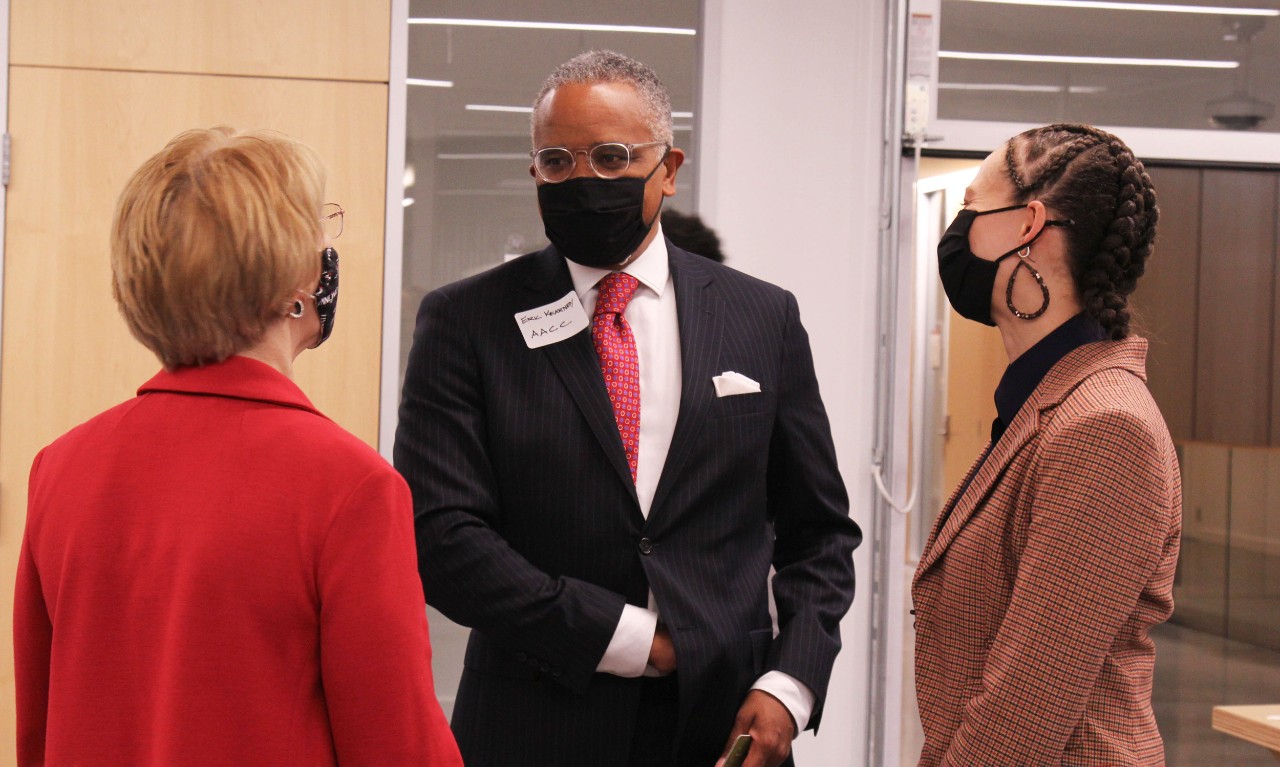 Three people speak in the Kautz Attic entrance.