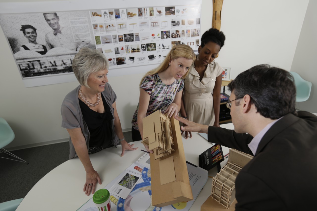 group standing together to examine an architectural statue