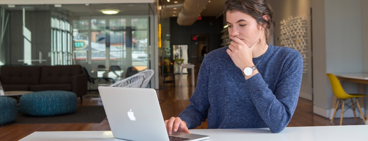 Student works on laptop writing a standout college essay