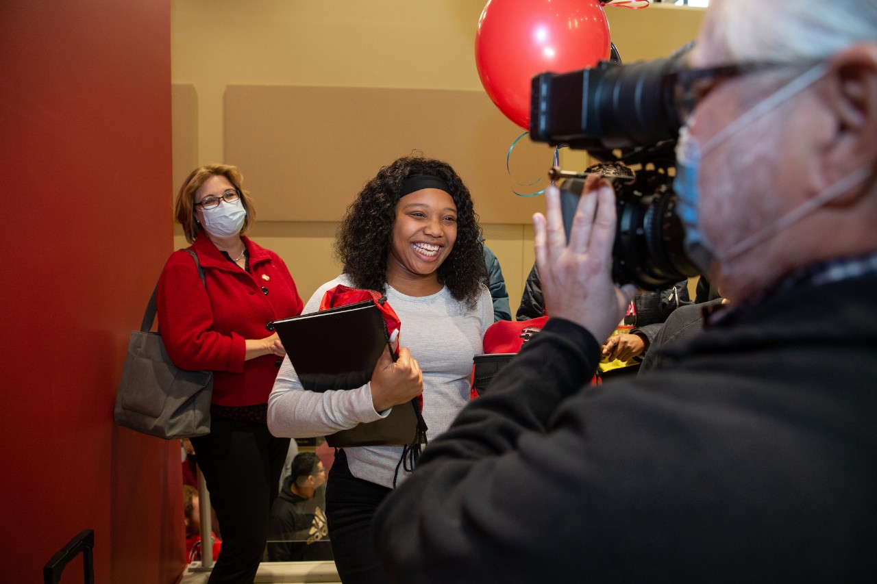Student smiling for a video camera