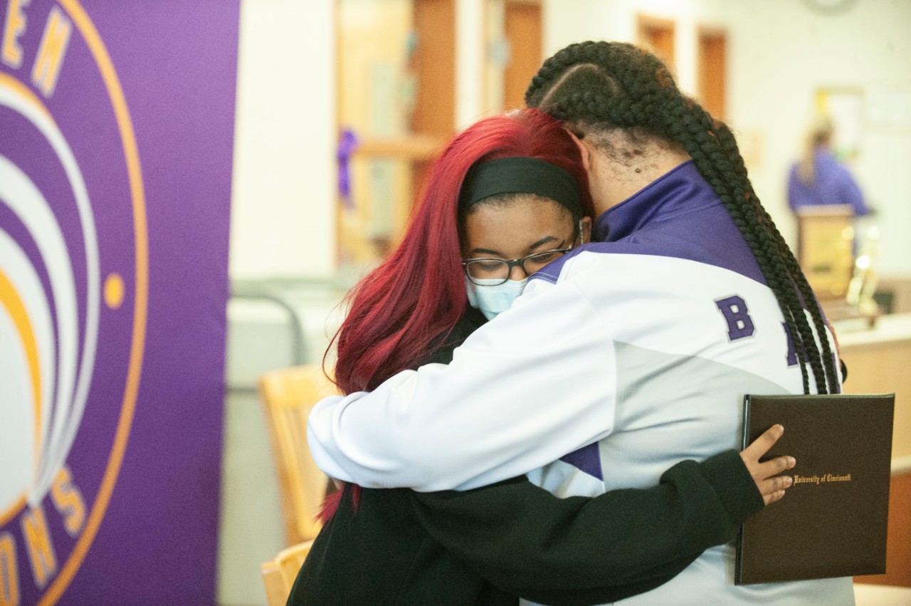 Jack Miner, Vice Provost for Enrollment Management surprised Ke’Ayra Rogers future UC Bearcats with Marian Spencer Scholarship award at Aiken High School Tuesday February 1, 2022. Marian Spencer Scholarship award students with full tuition, room and board and an all-expenses-paid study abroad experience from the University of Cincinnati. Photos by Joseph Fuqua II