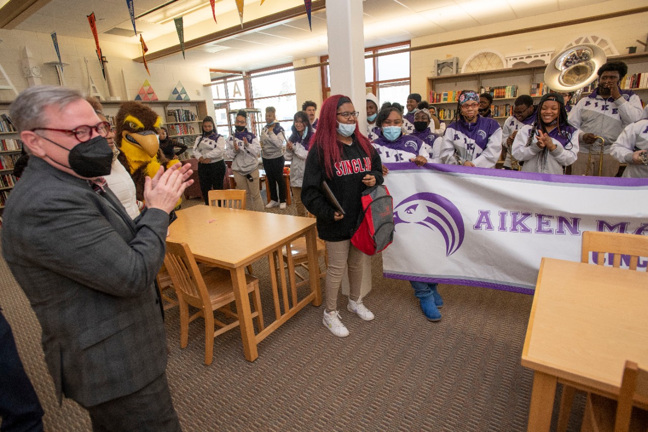 Jack Miner, Vice Provost for Enrollment Management surprised Ke’Ayra Rogers future UC Bearcats with Marian Spencer Scholarship award at Aiken High School Tuesday February 1, 2022. Marian Spencer Scholarship award students with full tuition, room and board and an all-expenses-paid study abroad experience from the University of Cincinnati. Photos by Joseph Fuqua II