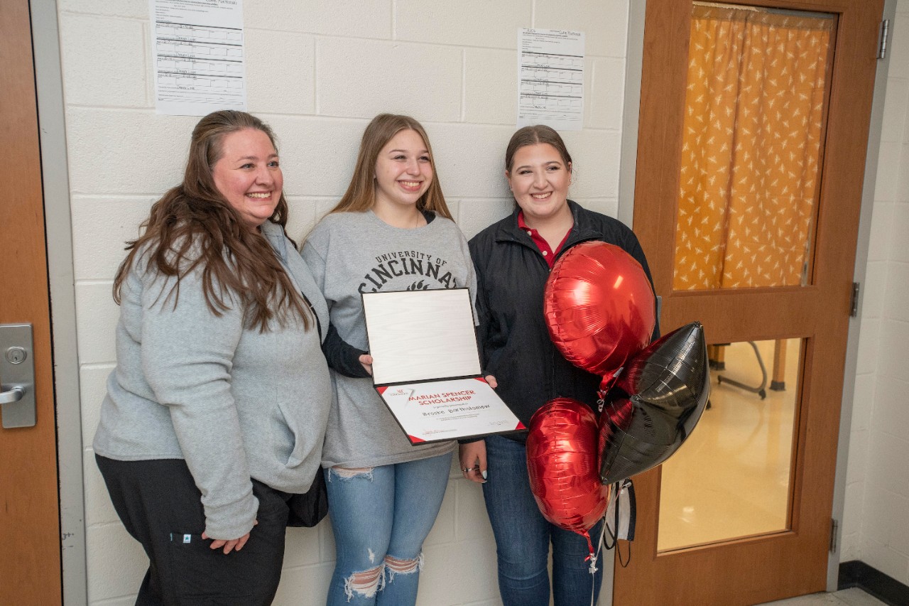 Jack Miner, Vice Provost for Enrollment Management surprised Brooke Bartholomew future UC Bearcats with Marian Spencer Scholarship award at Clark Montessori High School Tuesday February 1, 2022. Marian Spencer Scholarship award students with full tuition, room and board and an all-expenses-paid study abroad experience from the University of Cincinnati. Photos by Joseph Fuqua II