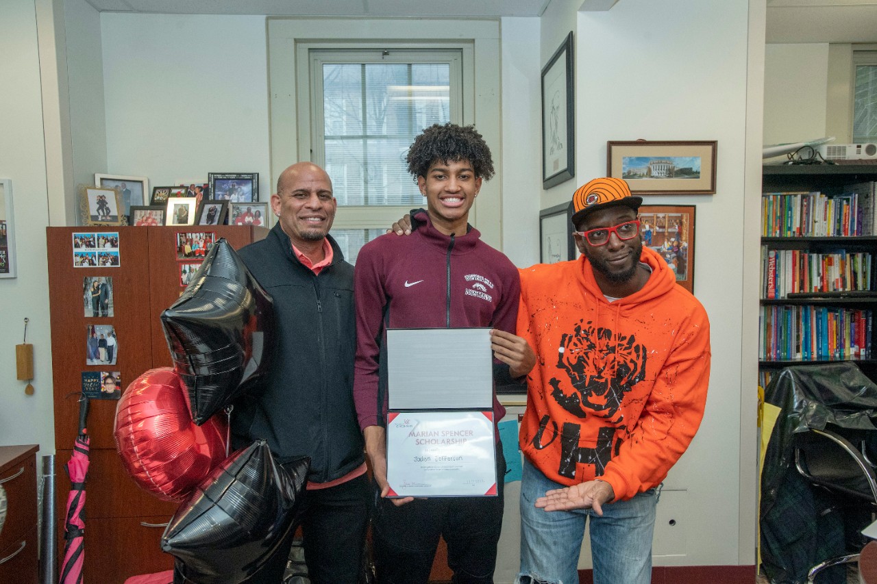 Jack Miner, Vice Provost for Enrollment Management surprised Jaden Jefferson future UC Bearcats with Marian Spencer Scholarship award at Western Hills High School Wednesday February 2, 2022. Marian Spencer Scholarship award students with full tuition, room and board and an all-expenses-paid study abroad experience from the University of Cincinnati. Photos by Joseph Fuqua II