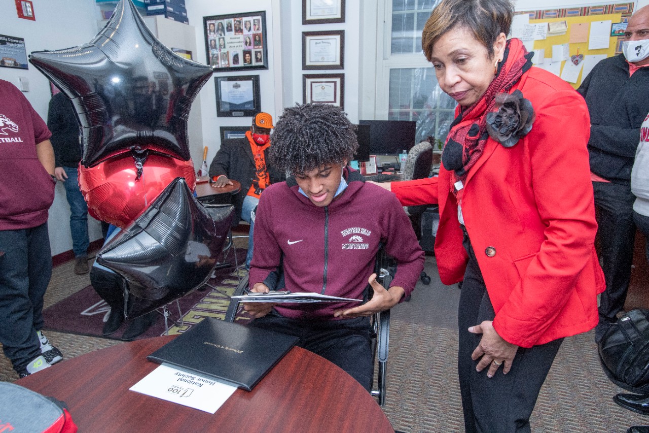 Jack Miner, Vice Provost for Enrollment Management surprised Jaden Jefferson future UC Bearcats with Marian Spencer Scholarship award at Western Hills High School Wednesday February 2, 2022. Marian Spencer Scholarship award students with full tuition, room and board and an all-expenses-paid study abroad experience from the University of Cincinnati. Photos by Joseph Fuqua II