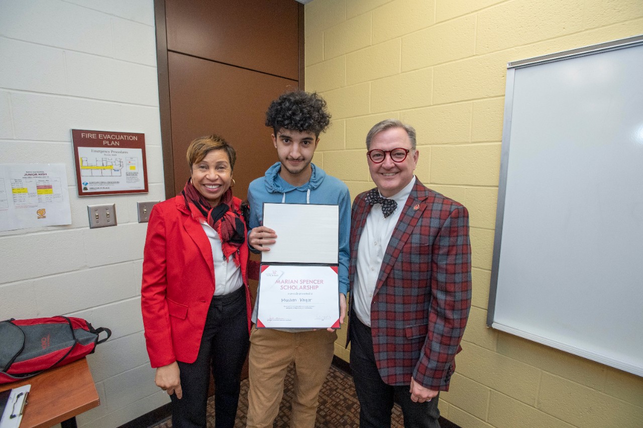 Jack Miner, Vice Provost for Enrollment Management surprised Muslim Khizr future UC Bearcats with Marian Spencer Scholarship award at Dater High School Wednesday February 2, 2022. Marian Spencer Scholarship award students with full tuition, room and board and an all-expenses-paid study abroad experience from the University of Cincinnati. Photos by Joseph Fuqua II