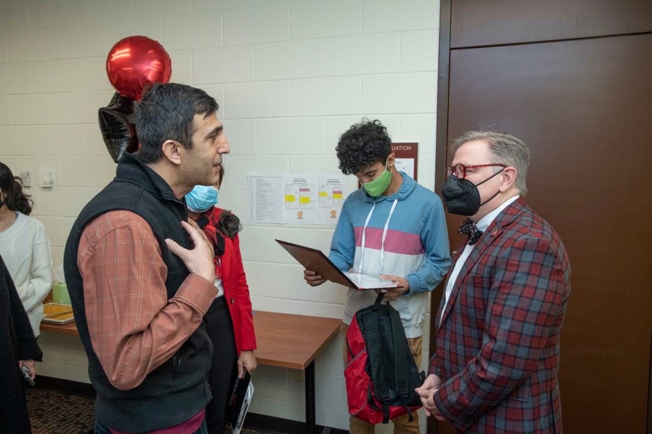 Jack Miner, Vice Provost for Enrollment Management surprised Muslim Khizr future UC Bearcats with Marian Spencer Scholarship award at Dater High School Wednesday February 2, 2022. Marian Spencer Scholarship award students with full tuition, room and board and an all-expenses-paid study abroad experience from the University of Cincinnati. Photos by Joseph Fuqua II