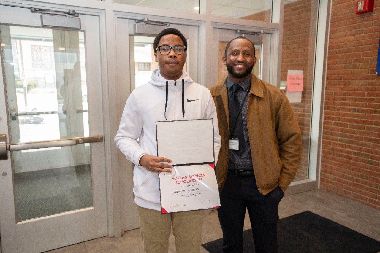 Jack Miner, Vice Provost for Enrollment Management surprised Maxwell Lawson future UC Bearcats with Marian Spencer Scholarship award at Spencer Center Tuesday February 1, 2022. Marian Spencer Scholarship award students with full tuition, room and board and an all-expenses-paid study abroad experience from the University of Cincinnati. Photos by Joseph Fuqua II