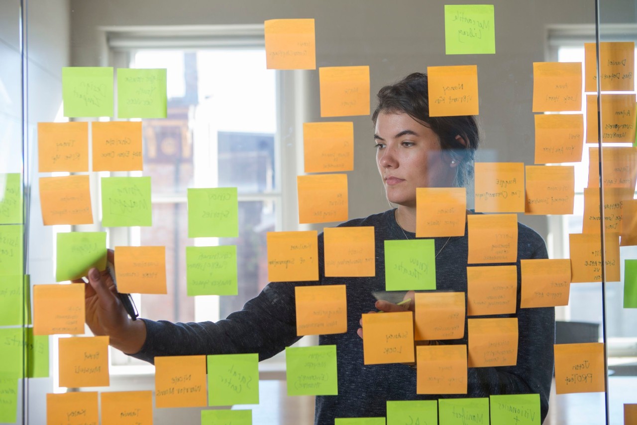 Student arranges post-it notes on window