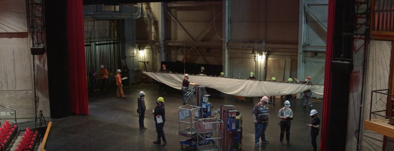CCM Professor Stirling Shelton works with students on the Patricia Corbett Theater stage in a scene from the CCM mini documentary "Ready, Set, Action!"