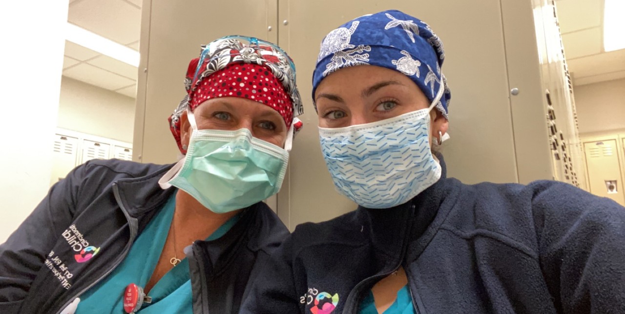 Cary (left) and Maddie Bell in scrubs and masks