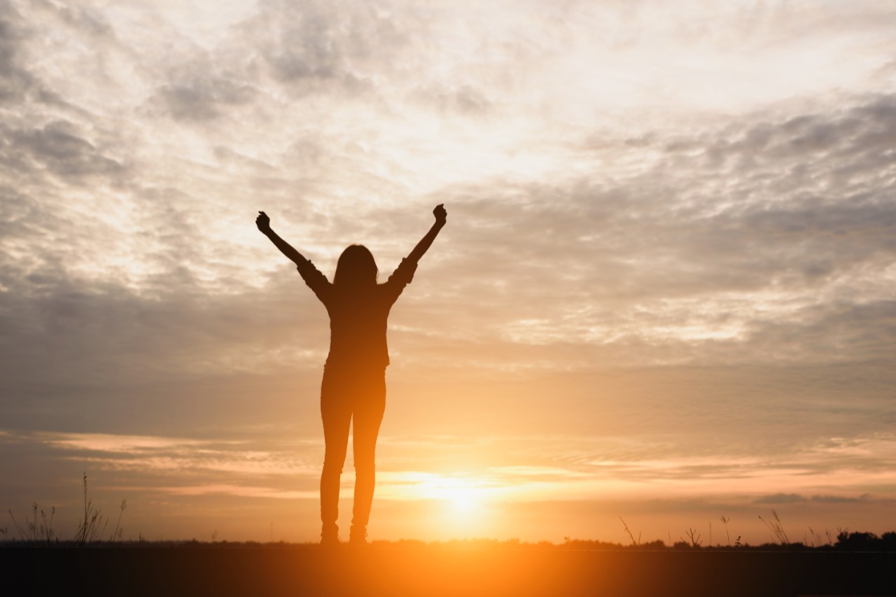 woman looking at sunset