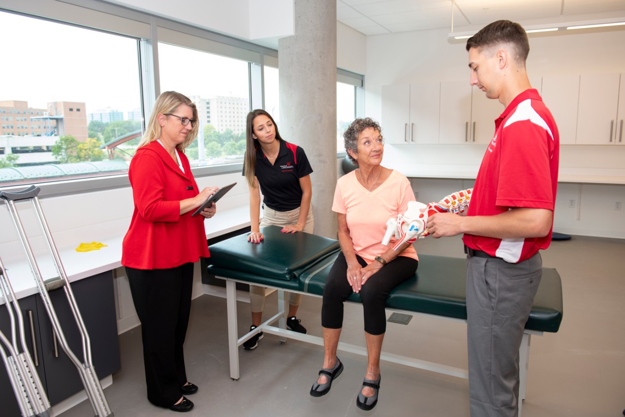 Faculty member instructs students in the physical therapy lab. 