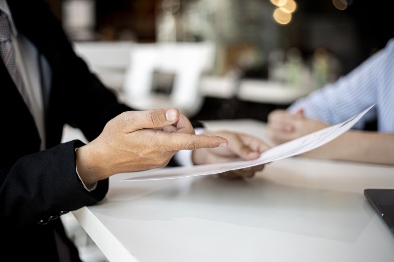 Two people review a document.