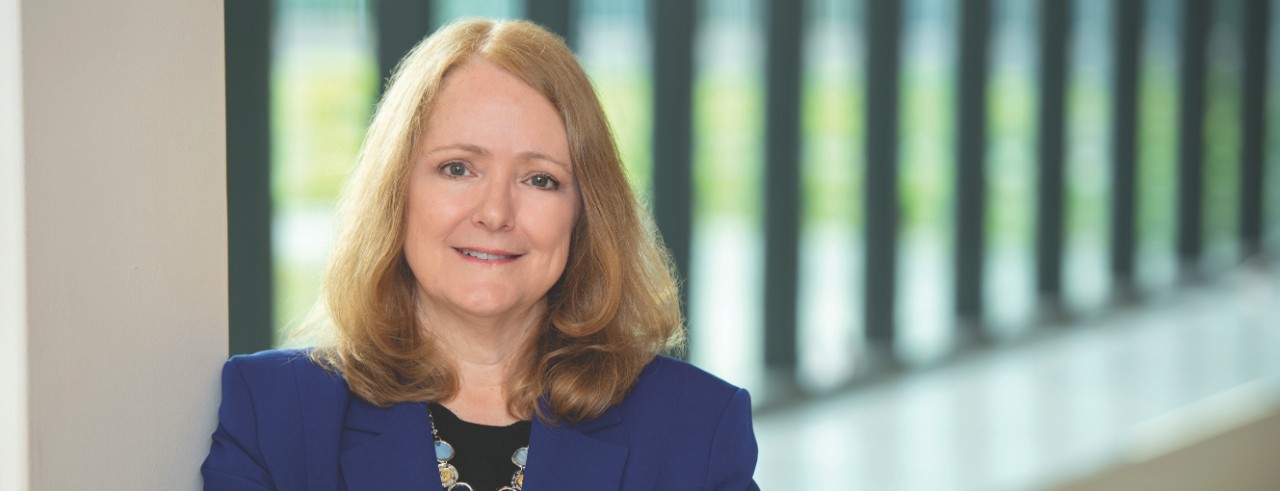 Tamilyn Bakas in front of windows in UC College of Nursing's Procter Hall