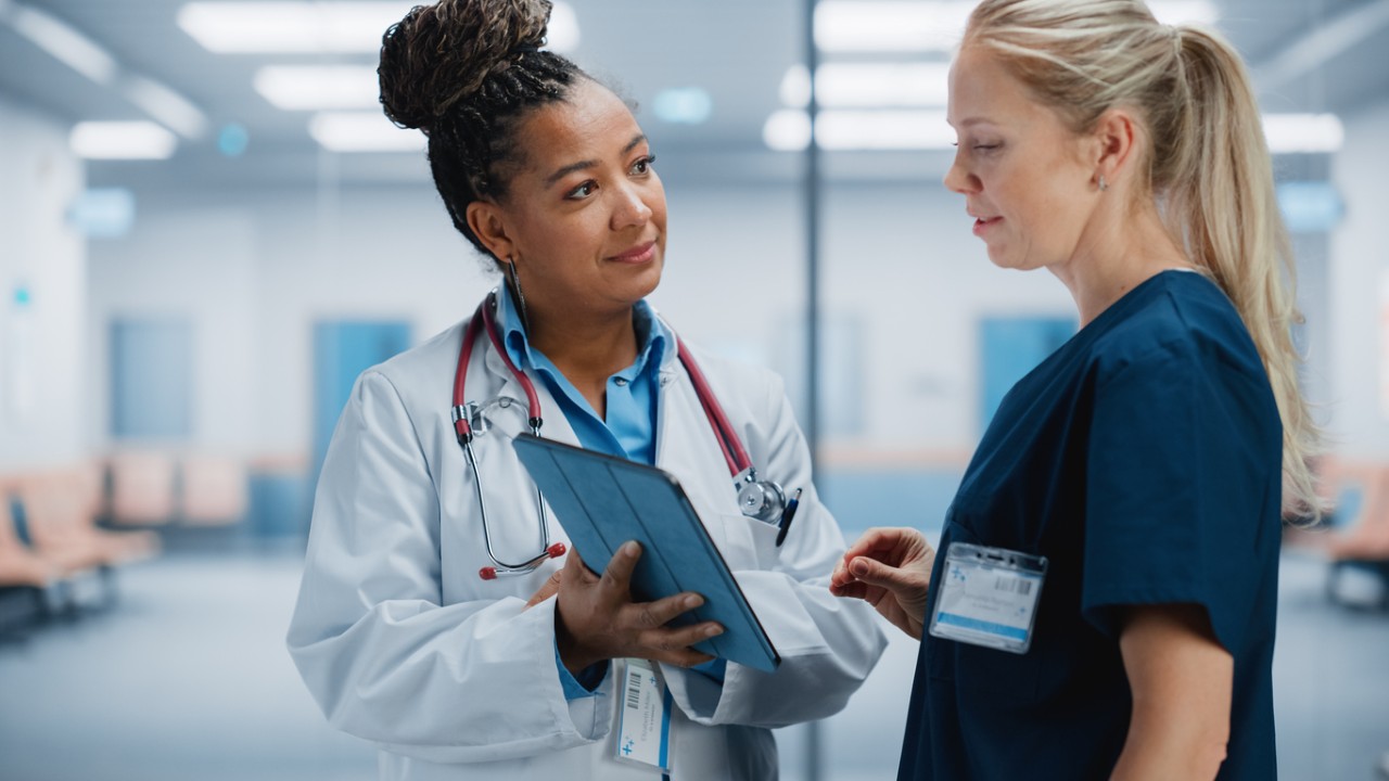 Two nurses talking in a clinic
