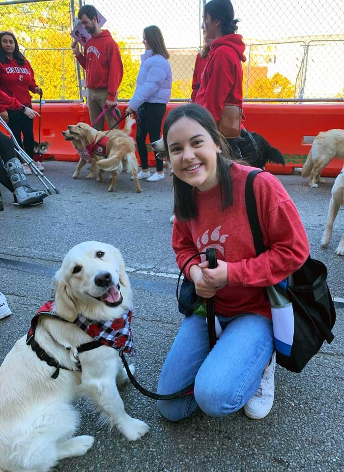 UC College of Nursing graduate Megan Peterson with Sparkle the golden Labrador Retriever