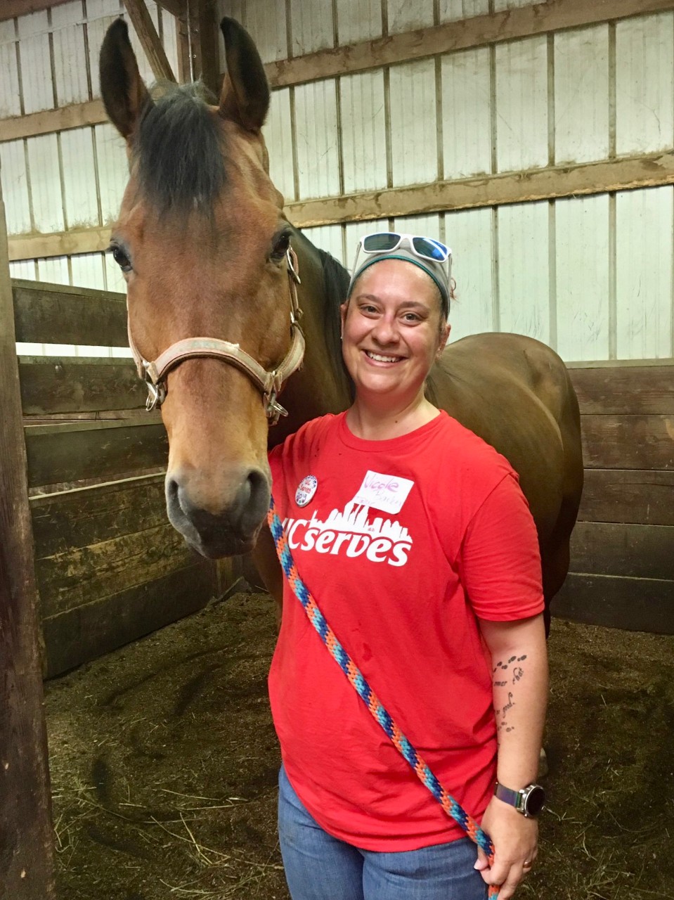 A UC Serves volunteer with a horse