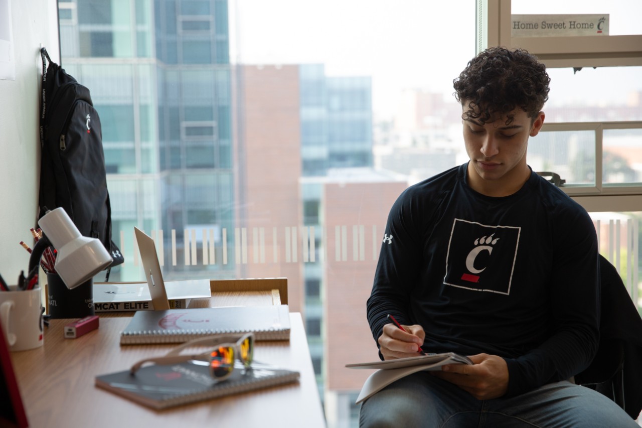 A University of Cincinnati student studies in their residence hall.