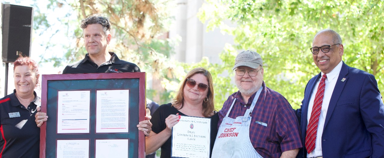 Dean Johnson accepts a certificate regarding the lawn named in his honor. 