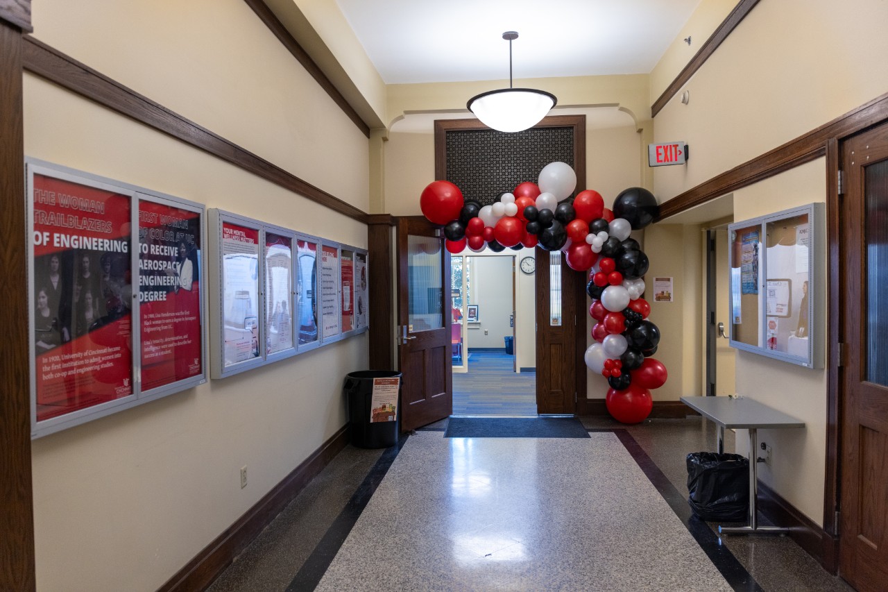 Red, white and black balloon arch outside of the student success center. 