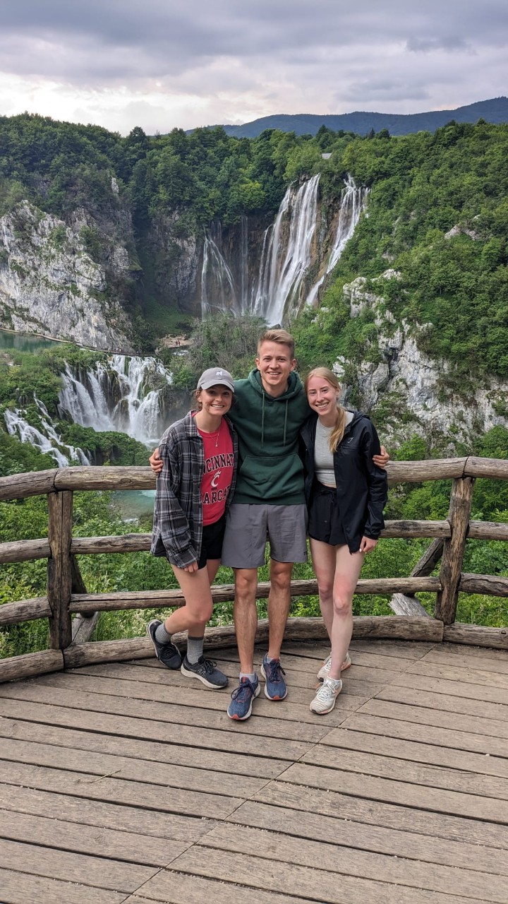Gretchen Spears (left) and friends pose in front of a mountain and waterfall