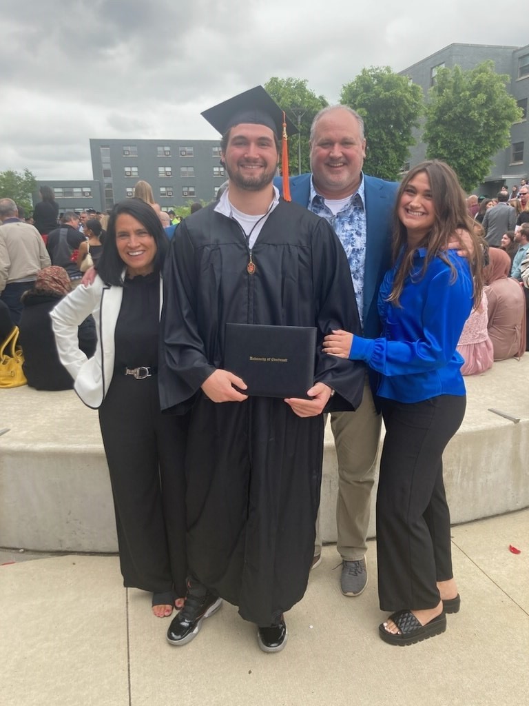 Will Mnich poses with his family at UC graduation
