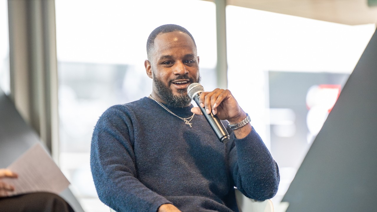 Eanes speaks at UC's annual Society of Sport Leaders Symposium. Eanes was a part of the first graduating class of the Sport Administration Program. 