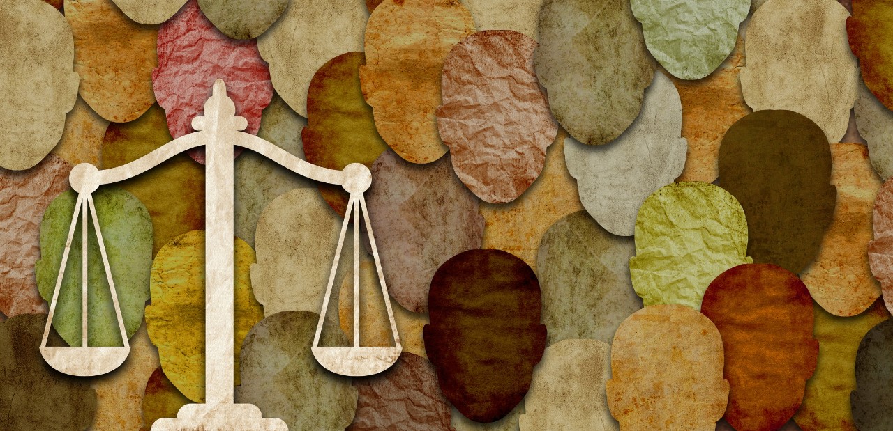 graphic of different ethnic heads with scales of justice. 