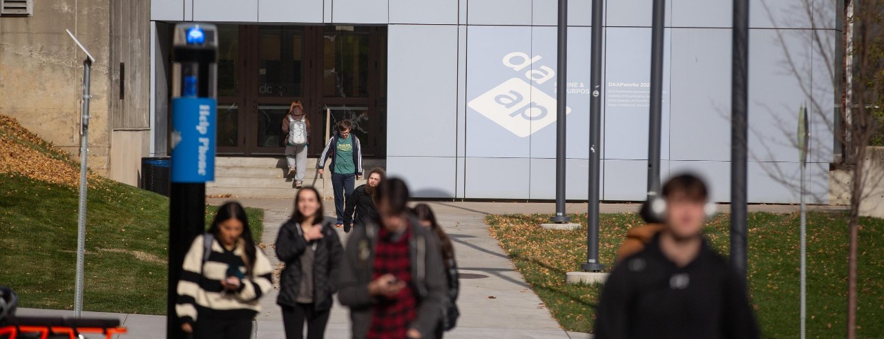 students exiting a building on the University of Cincinnati campus