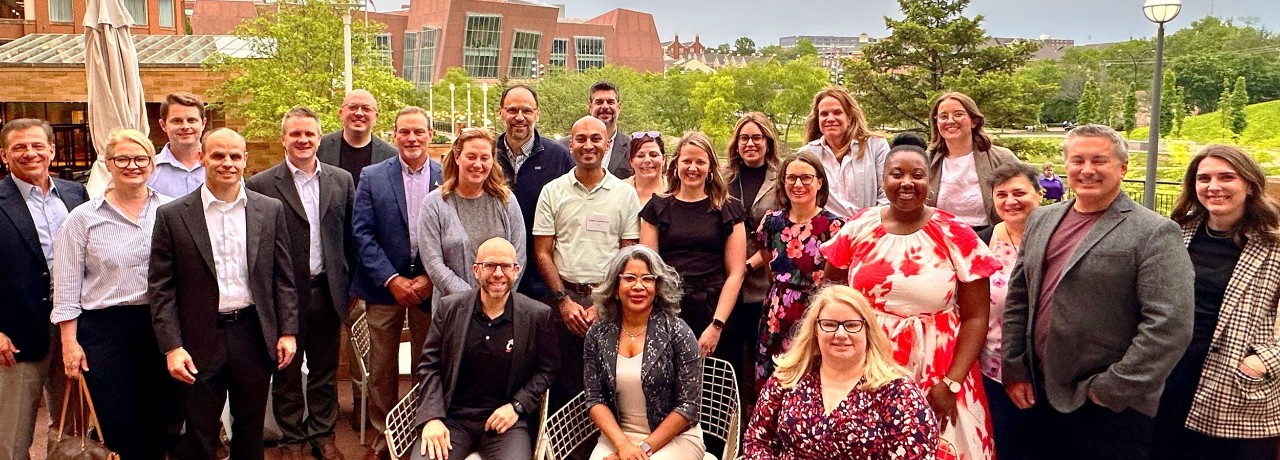 Industry advisory cabinet members at inaugural meeting with CCPS leadership and staff. Two dozen individuals shown posing for a photo outside.