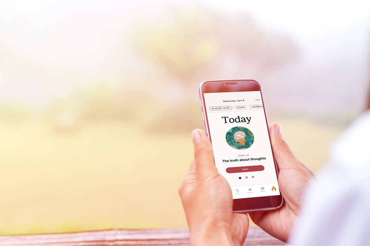 A person holds a phone in their hands that is displaying the Stanza smartphone app to help manage fibromyalgia symptoms