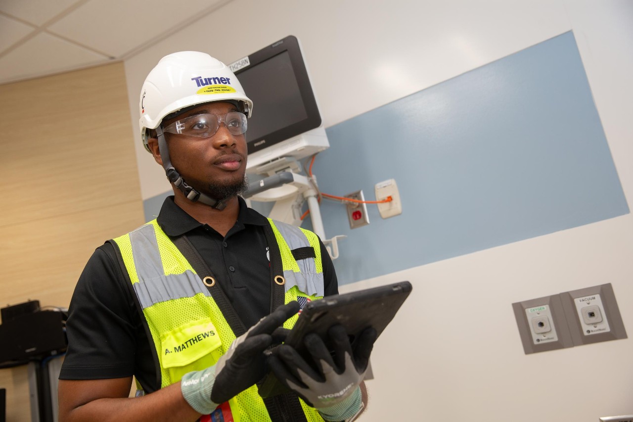 Engineering co-op student Andrew Matthews works with Turner employee (and former UC co-op) Jalyn Stewart at a Turner Construction site at Bethesda North Hospital.