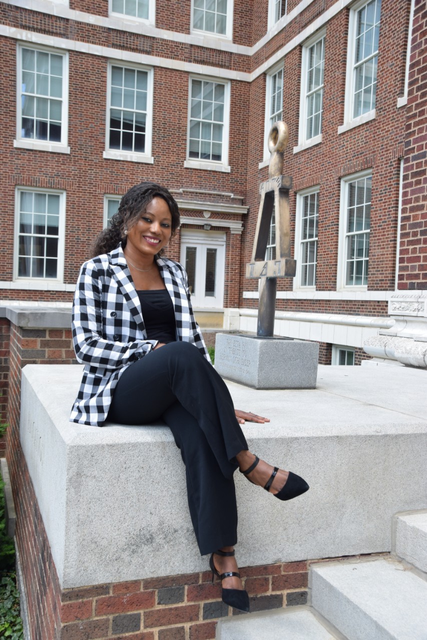 Nkechi Jennifer Akinwale sits outside of UC's Baldwin Hall