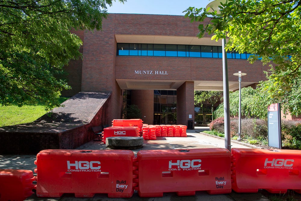 Orange construction barriers outside of Muntz Hall