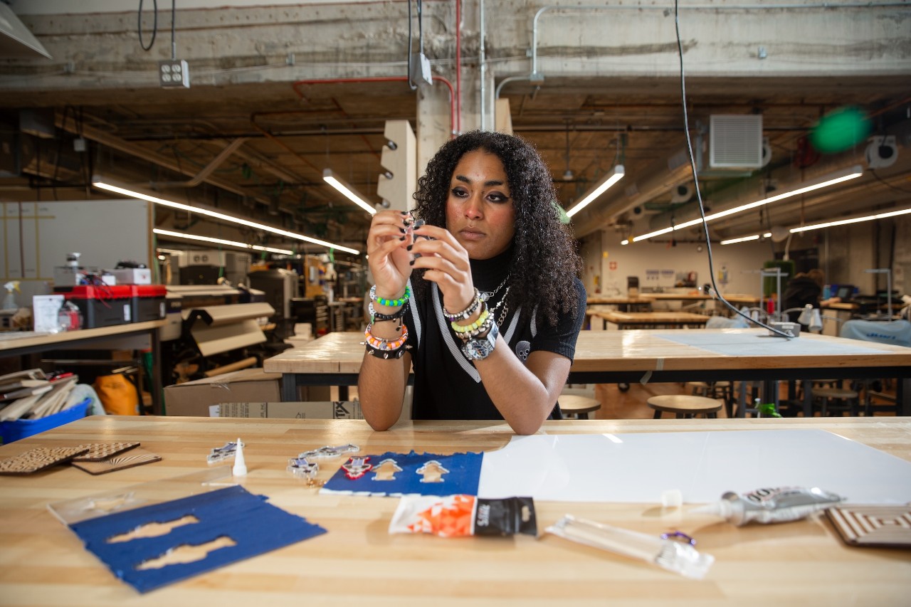 Nukes de Almeida Nuku-Graves, BFA student, digital artist & video game developer, and creator of the game cryptid coffeehouse, at the Maker's Space in 1819.